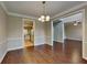 Open-concept dining area offers views to the kitchen and another living space beyond the doorway at 2312 Mahogany Glen Pl, Lawrenceville, GA 30043