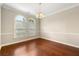 Dining room with rich hardwood flooring and classic chandelier fixture with chair railing at 2312 Mahogany Glen Pl, Lawrenceville, GA 30043