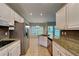 Modern kitchen featuring granite countertops, stainless steel appliances, and tile flooring at 2312 Mahogany Glen Pl, Lawrenceville, GA 30043