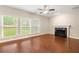 Spacious living room with hardwood floors, a fireplace, and natural light from large windows at 2312 Mahogany Glen Pl, Lawrenceville, GA 30043