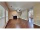 Bright living room with a cozy fireplace, hardwood floors, and natural light streaming through large windows at 2312 Mahogany Glen Pl, Lawrenceville, GA 30043