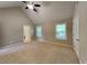 The main bedroom features plush carpeting, vaulted ceiling, and two windows for natural light at 2312 Mahogany Glen Pl, Lawrenceville, GA 30043
