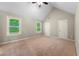 Spacious main bedroom featuring neutral carpet, a ceiling fan, and windows allowing natural light to fill the room at 2312 Mahogany Glen Pl, Lawrenceville, GA 30043
