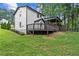 The home has a backyard featuring a raised back porch and beautiful landscaping at 5006 Dekalb Way, Stone Mountain, GA 30087
