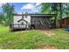 The home has a backyard featuring a raised back porch and beautiful landscaping at 5006 Dekalb Way, Stone Mountain, GA 30087