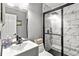 Updated bathroom with black fixtures, and large walk-in shower with black framed glass doors at 5006 Dekalb Way, Stone Mountain, GA 30087