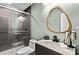This bathroom features a nice modern vanity with a custom mirror and a glassed-in shower at 5006 Dekalb Way, Stone Mountain, GA 30087