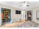 Bedroom with closet systems, TV, light colored walls, and wood floors at 5006 Dekalb Way, Stone Mountain, GA 30087