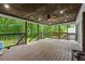 Relaxing covered deck with ceiling fan and hammock overlooking a green backyard with mature trees at 5006 Dekalb Way, Stone Mountain, GA 30087
