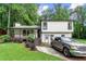 Charming two-story home with a covered front porch, manicured lawn, and a driveway with parking at 5006 Dekalb Way, Stone Mountain, GA 30087