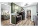 Functional kitchen with stainless steel appliances, and wood-look flooring, offering access to living areas at 5006 Dekalb Way, Stone Mountain, GA 30087