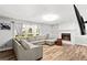 Bright living room featuring a fireplace, wood-look floors, and a comfortable sectional sofa at 5006 Dekalb Way, Stone Mountain, GA 30087
