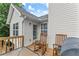 Charming back deck with rocking chairs, a grill, and a view of the house's exterior at 8436 Cyprus Ridge Way, Douglasville, GA 30134