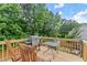 Relaxing back deck with seating, grill, and wooded view, perfect for outdoor entertaining at 8436 Cyprus Ridge Way, Douglasville, GA 30134