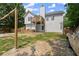 View of the backyard featuring a deck, fence, grass and a shed-style structure, and unique, rustic decoration at 8436 Cyprus Ridge Way, Douglasville, GA 30134