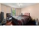 Comfortable bedroom with hardwood floors, ceiling fan, and natural light from the window at 8436 Cyprus Ridge Way, Douglasville, GA 30134