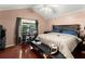 Cozy bedroom features hardwood floors, a vaulted ceiling, and neutral paint at 8436 Cyprus Ridge Way, Douglasville, GA 30134