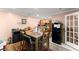 Inviting dining area with a wooden table, view into the kitchen, and a black refrigerator at 8436 Cyprus Ridge Way, Douglasville, GA 30134