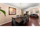 Formal dining room featuring a chandelier, wooden table, seating for six, and view to living room at 8436 Cyprus Ridge Way, Douglasville, GA 30134