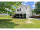 Side view of a two-story home with green grass and a two car garage at 8436 Cyprus Ridge Way, Douglasville, GA 30134
