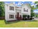 Inviting two-story home featuring a cozy front porch and lush green lawn at 8436 Cyprus Ridge Way, Douglasville, GA 30134