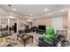 Relaxing living room with tile floor, large screen TV, comfortable seating, and a playful green dinosaur plush at 8436 Cyprus Ridge Way, Douglasville, GA 30134