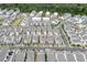 Aerial view of a dense neighborhood with white homes, tree-lined streets, and community layout at 1023 Harvest Park Ln, Suwanee, GA 30024