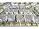 An aerial view showcases a neighborhood of modern, white homes with well-maintained lawns and landscaping at 1023 Harvest Park Ln, Suwanee, GA 30024