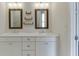 Bright bathroom featuring dual sinks, elegant mirrors, and ample storage, perfect for a fresh start at 1023 Harvest Park Ln, Suwanee, GA 30024