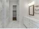 Elegant bathroom with marble tile, glass-enclosed shower, and double vanity, offering luxury and functionality at 1023 Harvest Park Ln, Suwanee, GA 30024