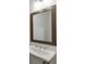 Bathroom featuring a pedestal sink with a modern faucet and a wood-framed mirror at 1023 Harvest Park Ln, Suwanee, GA 30024
