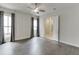 Spacious bedroom with hardwood floors, modern ceiling fan, and double doors to en-suite bathroom at 1023 Harvest Park Ln, Suwanee, GA 30024