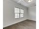 Bright bedroom featuring hardwood floors, natural light from a window, and elegant trim details at 1023 Harvest Park Ln, Suwanee, GA 30024