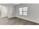 Cozy bedroom features hardwood floors, neutral walls, and a window offering a bright, airy ambiance at 1023 Harvest Park Ln, Suwanee, GA 30024