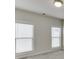 Bedroom featuring two windows that offer natural light and blinds at 1023 Harvest Park Ln, Suwanee, GA 30024