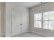 Bedroom showcasing large windows with blinds for natural light and a double door closet at 1023 Harvest Park Ln, Suwanee, GA 30024