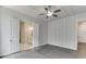 Bright, spacious bedroom featuring hardwood floors, ceiling fan, and paneled accent walls at 1023 Harvest Park Ln, Suwanee, GA 30024