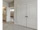 Bright bedroom featuring white closet doors, neutral carpet, and views of the en-suite bathroom and hallway at 1023 Harvest Park Ln, Suwanee, GA 30024