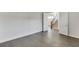 Spacious bedroom boasts hardwood floors, neutral walls, and doorways to other rooms at 1023 Harvest Park Ln, Suwanee, GA 30024
