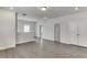 Spacious bonus room area with an open floor plan and gray wood floors at 1023 Harvest Park Ln, Suwanee, GA 30024