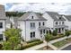 Charming two-story white home with manicured landscaping, covered entry, and many windows at 1023 Harvest Park Ln, Suwanee, GA 30024