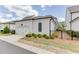 View of the white siding of the home, black accent shutters and a two-car garage at 1023 Harvest Park Ln, Suwanee, GA 30024