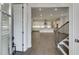 Inviting interior showcases hardwood floors, an open floor plan, and modern kitchen with bright white cabinetry at 1023 Harvest Park Ln, Suwanee, GA 30024
