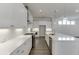 Bright, modern kitchen with white cabinets, stainless steel appliances, and an expansive island with quartz countertop at 1023 Harvest Park Ln, Suwanee, GA 30024