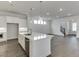 Modern kitchen with white island, stainless steel appliances, recessed lights and hardwood floors at 1023 Harvest Park Ln, Suwanee, GA 30024
