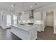 Contemporary kitchen with island, stainless appliances, stylish pendant lights, and hardwood floors at 1023 Harvest Park Ln, Suwanee, GA 30024