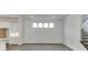 Living room with hardwood floors, shiplap wall, recessed lights and access to staircase at 1023 Harvest Park Ln, Suwanee, GA 30024