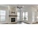 Inviting living room features a stone fireplace, hardwood floors, and natural light from multiple windows at 1023 Harvest Park Ln, Suwanee, GA 30024