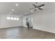 Spacious living room featuring recessed lighting, gray hardwood flooring, and staircase access to upper level at 1023 Harvest Park Ln, Suwanee, GA 30024
