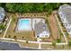 A community pool area with lounge chairs, landscaping, and a clubhouse, offers a relaxing outdoor space at 1023 Harvest Park Ln, Suwanee, GA 30024